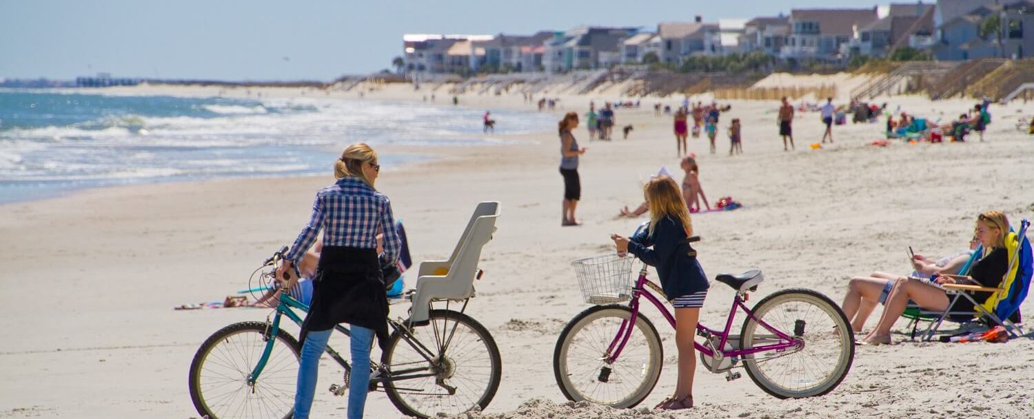 family on bikes on the beach