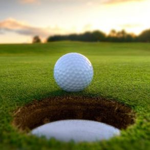 a golf ball next to a hole