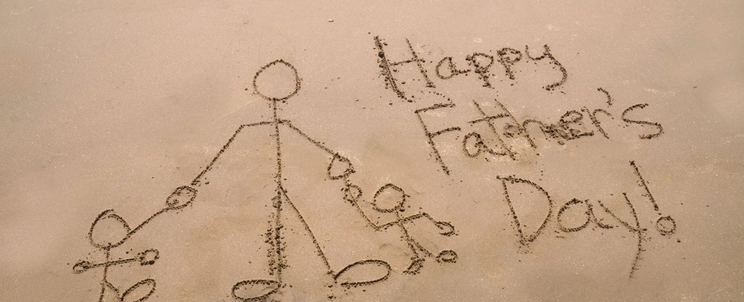 Happy Father's Day written in the sand