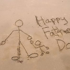 Happy Father's Day written in the sand