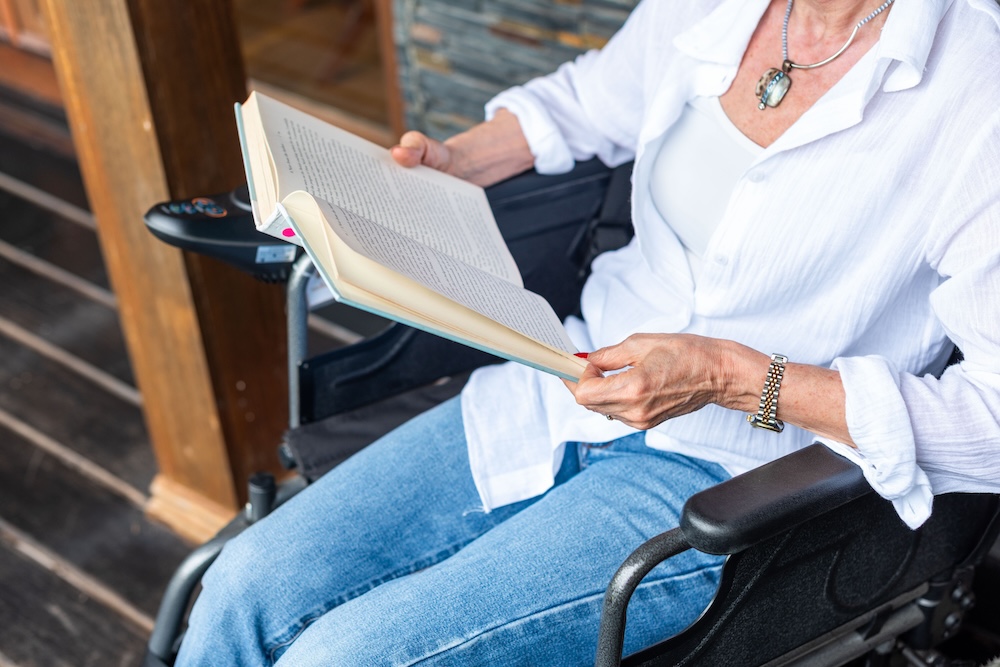 Reading outdoors in wheelchair