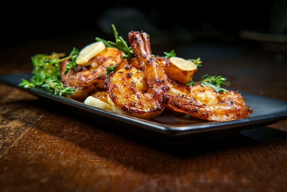 Authentic Portuguese Garlic Shrimp garnished with rosemary and thyme