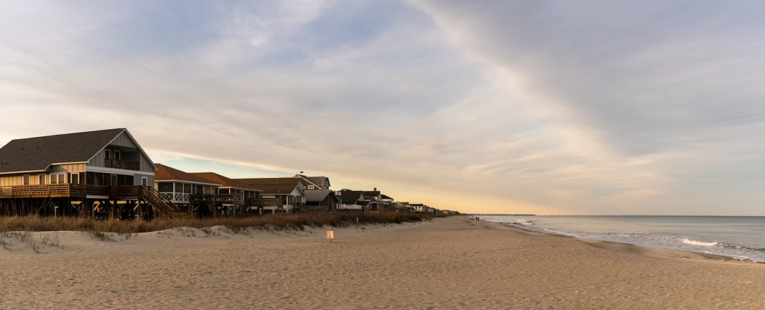 Pawleys Island, USA - 17 March, 2026: panorama view of the first row homes and endless beach of Pawleys Island at sunrise