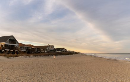Pawleys Island, USA - 17 March, 2026: panorama view of the first row homes and endless beach of Pawleys Island at sunrise